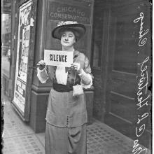 Suffragist holding sign, 1914